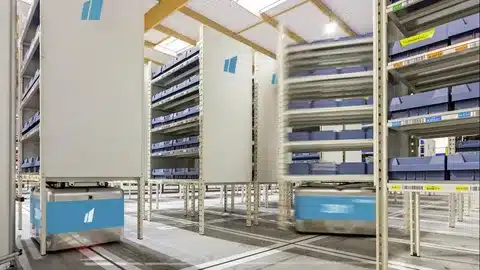 “Automated robots moving racks in modern fulfillment warehouse for efficient order processing”